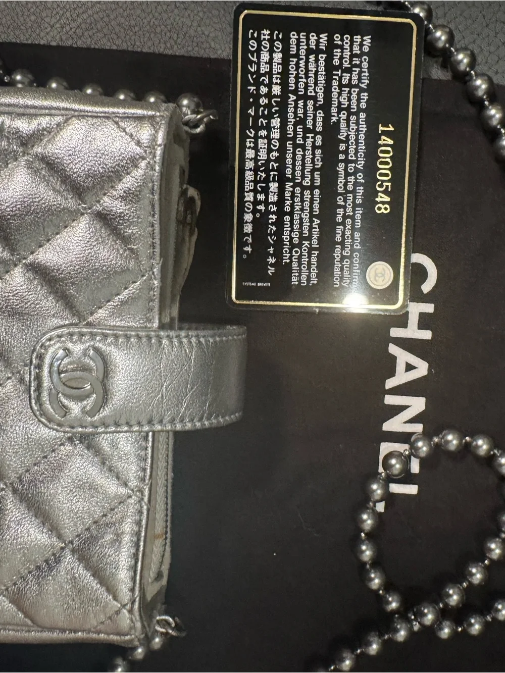 CHANEL Silver Quilted Leather O-Phone Holder with Pearl Chain.